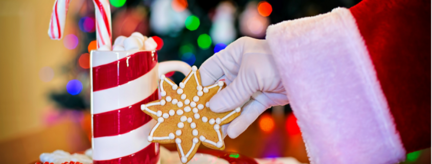 Image of Santa's gloved hand reaching for a Christmas cookie